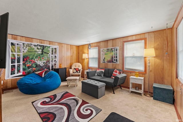 carpeted living room featuring wooden walls and a healthy amount of sunlight