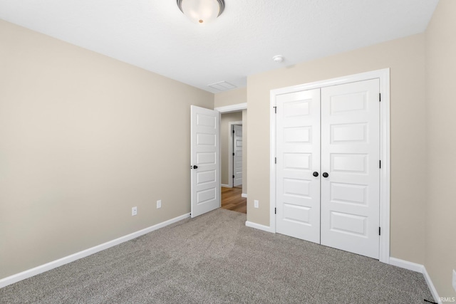 unfurnished bedroom with carpet floors and a closet