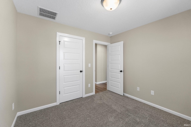 unfurnished bedroom featuring a closet and carpet flooring