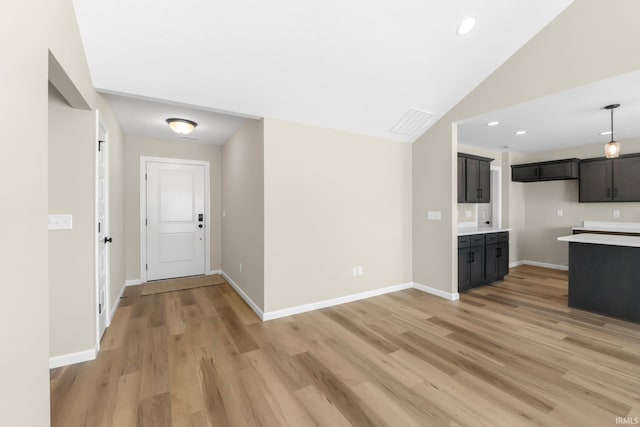 kitchen featuring lofted ceiling and light wood-type flooring