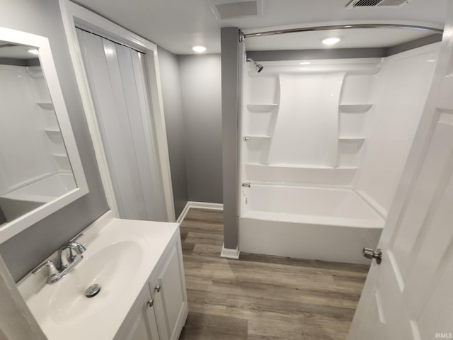 bathroom featuring shower / tub combination, vanity, and hardwood / wood-style flooring