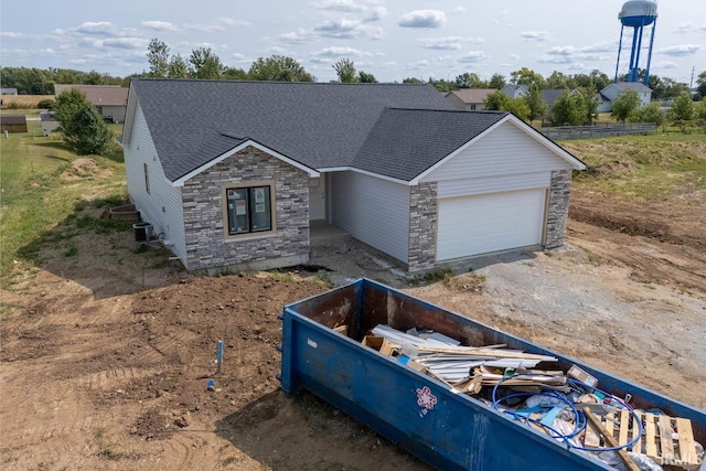 view of front facade featuring central air condition unit and a garage