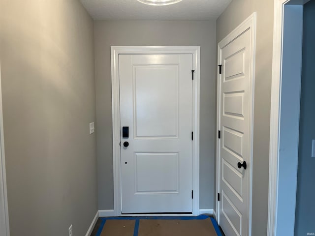 doorway featuring a textured ceiling