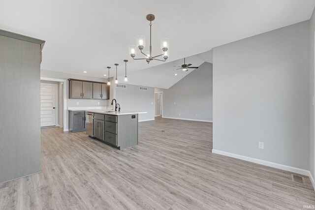 602 Zion Hill Rd, Ligonier, IN 46767 - kitchen with light countertops, light wood finished floors, open floor plan, a kitchen island with sink, and ceiling fan with notable chandelier