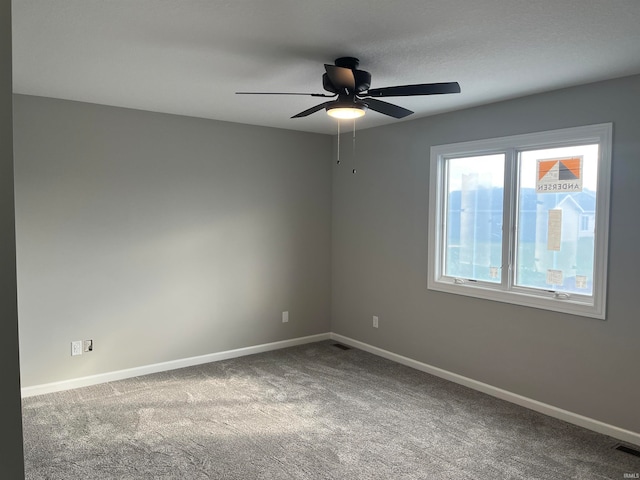 spare room featuring ceiling fan and carpet flooring