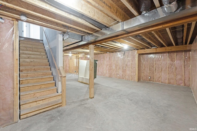 basement featuring wood walls