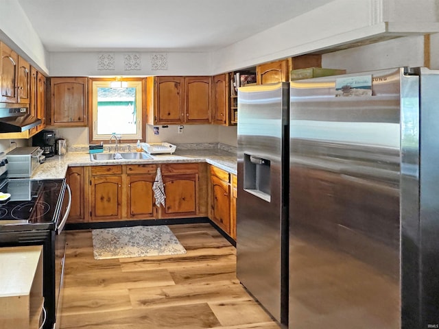 kitchen with stainless steel refrigerator with ice dispenser, sink, electric range, light hardwood / wood-style flooring, and range hood