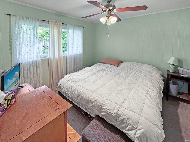 bedroom with ceiling fan and ornamental molding