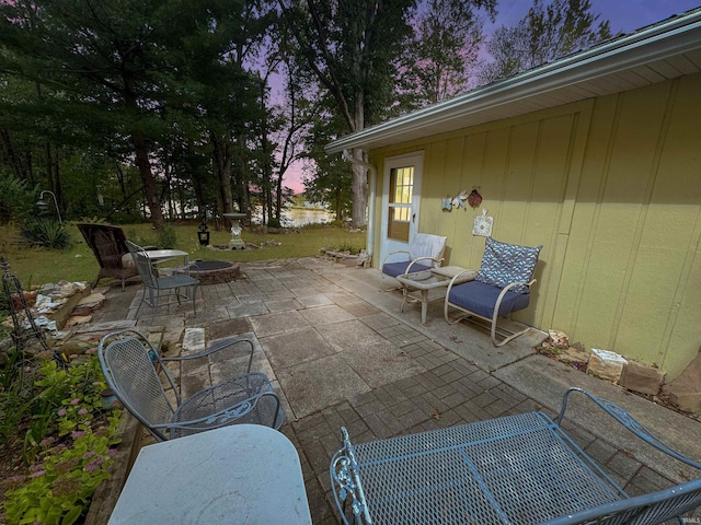 patio terrace at dusk featuring a fire pit