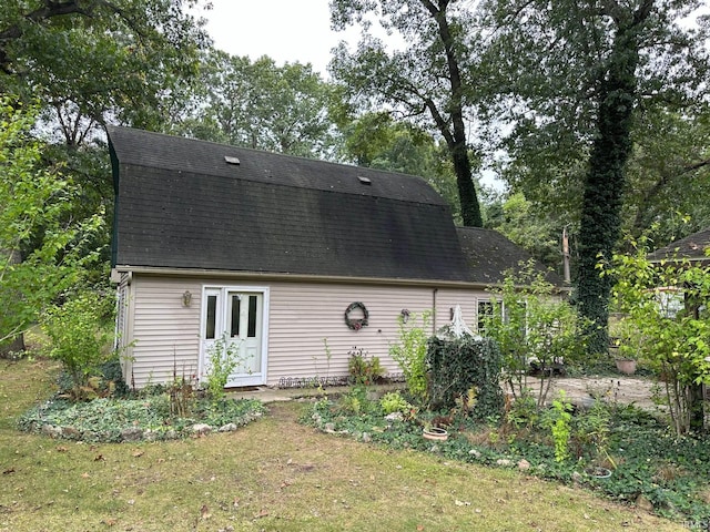 rear view of property featuring a yard