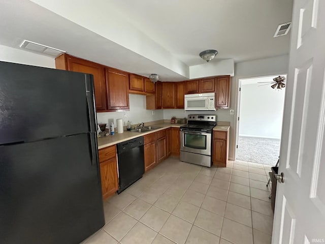 kitchen featuring ceiling fan, sink, light tile patterned floors, and black appliances