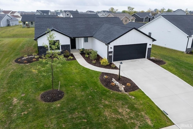 modern inspired farmhouse with a garage and a front yard