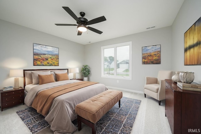 bedroom featuring light carpet and ceiling fan