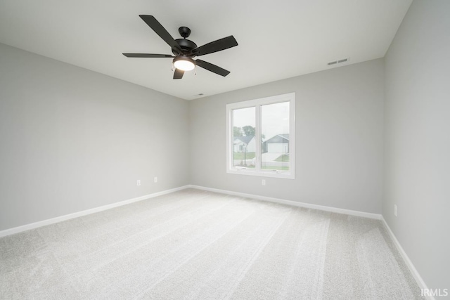 empty room featuring ceiling fan and carpet floors