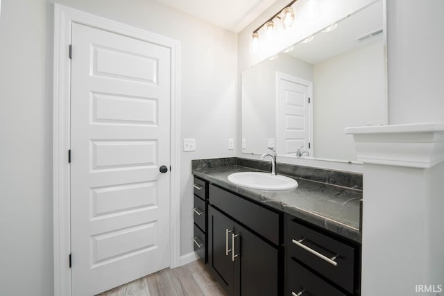 bathroom with hardwood / wood-style flooring and vanity