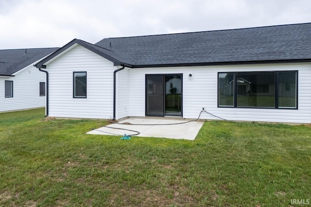 rear view of house featuring a yard and a patio area