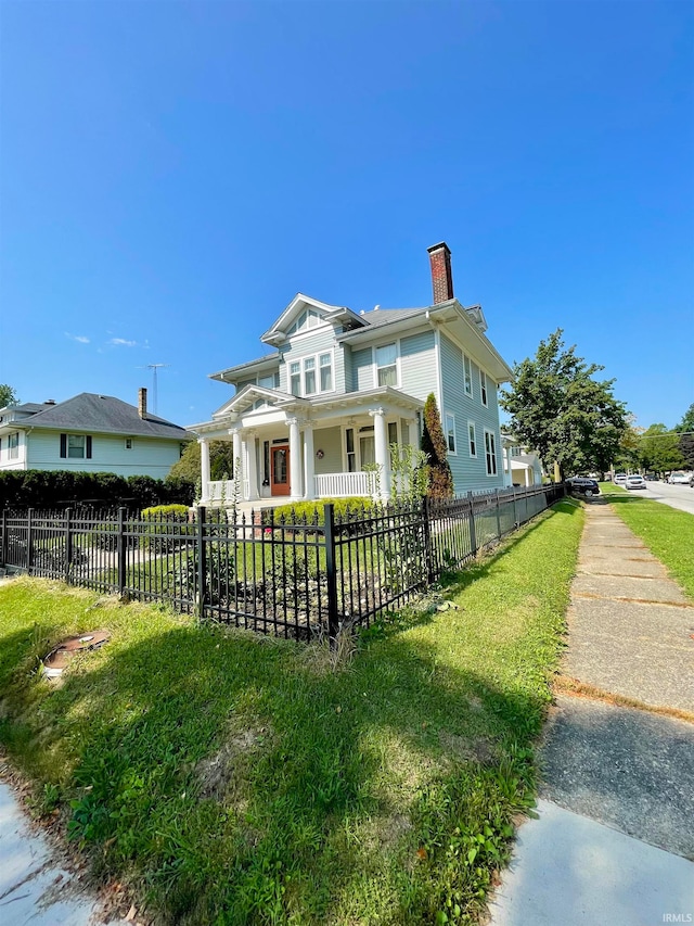 view of front of home featuring a fenced front yard, a chimney, and a front yard