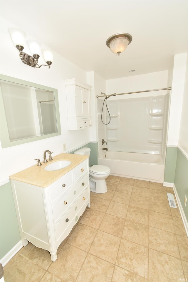 full bathroom featuring vanity, toilet,  shower combination, and tile patterned floors