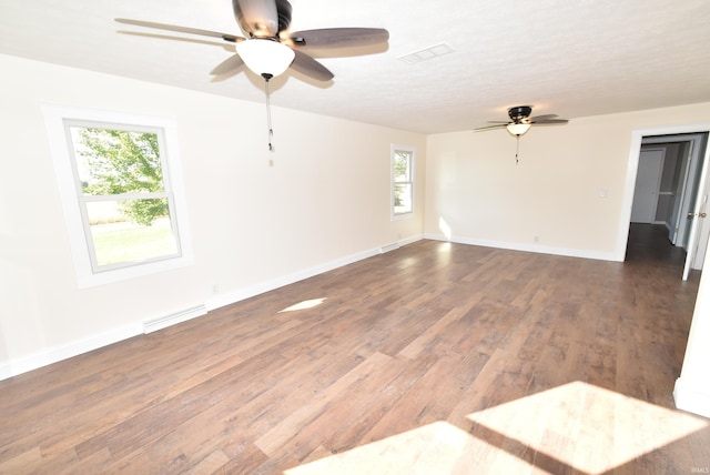 spare room with ceiling fan and dark hardwood / wood-style flooring