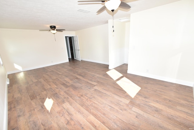 empty room with ceiling fan, hardwood / wood-style floors, and a textured ceiling