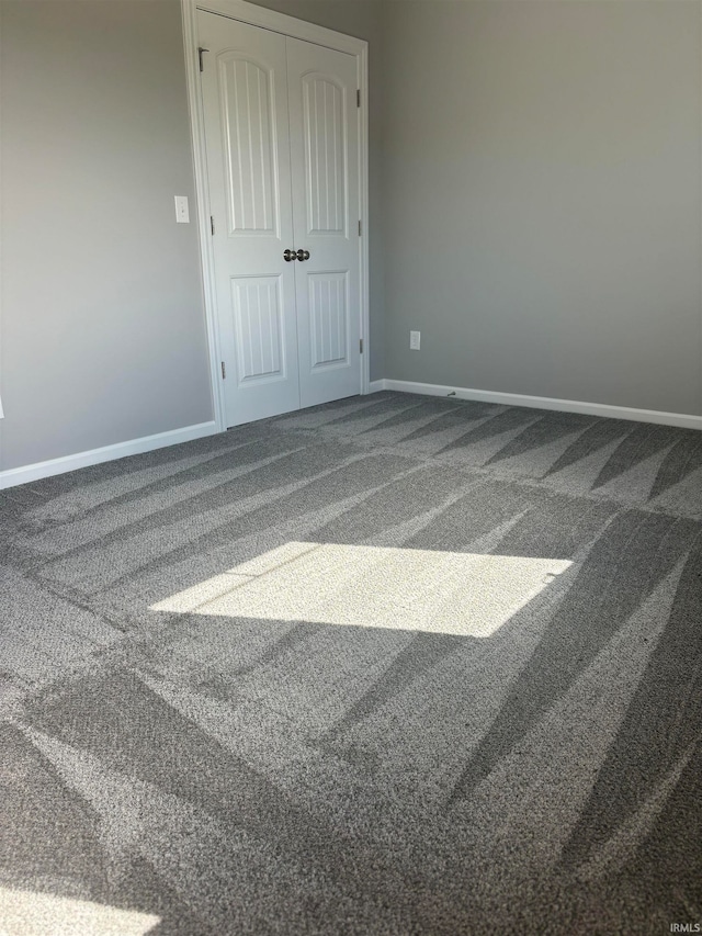 unfurnished bedroom with a closet and carpet flooring