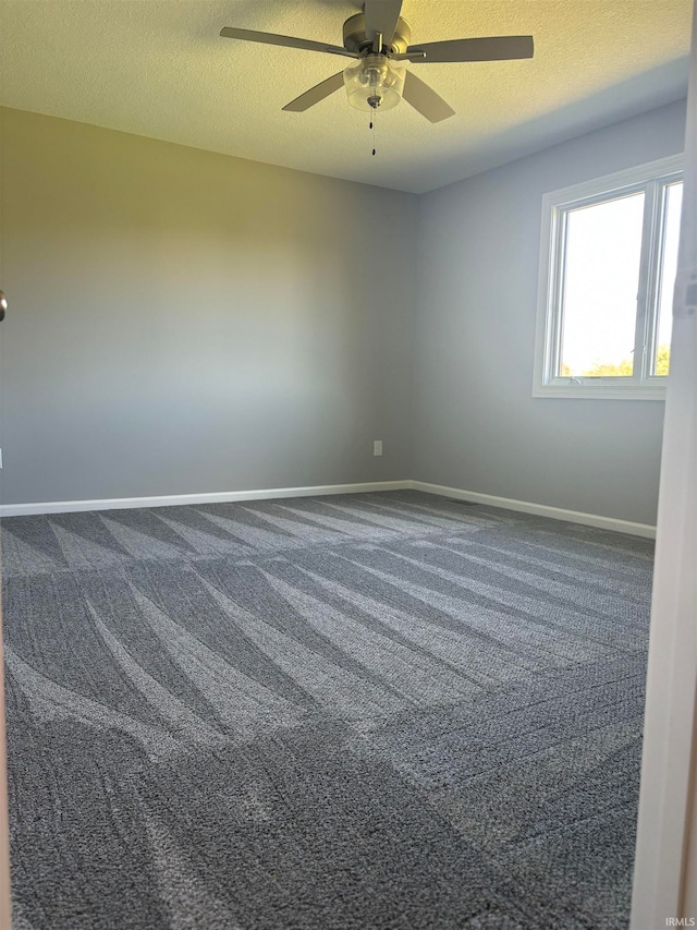 carpeted empty room featuring a textured ceiling and ceiling fan