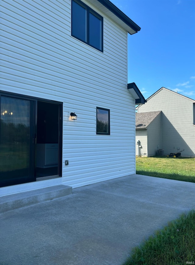 view of home's exterior with a patio area and central air condition unit