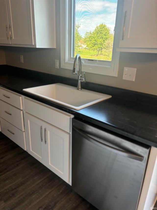 kitchen with dishwasher, sink, dark hardwood / wood-style flooring, and white cabinetry