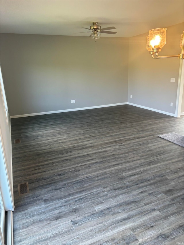 spare room featuring ceiling fan and dark wood-type flooring