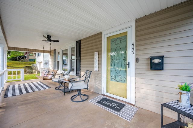 entrance to property with ceiling fan and covered porch