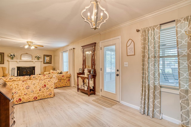 interior space with light wood-type flooring, ceiling fan, plenty of natural light, and crown molding