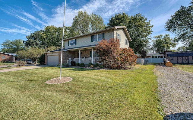 view of property with a garage, a front lawn, and a porch