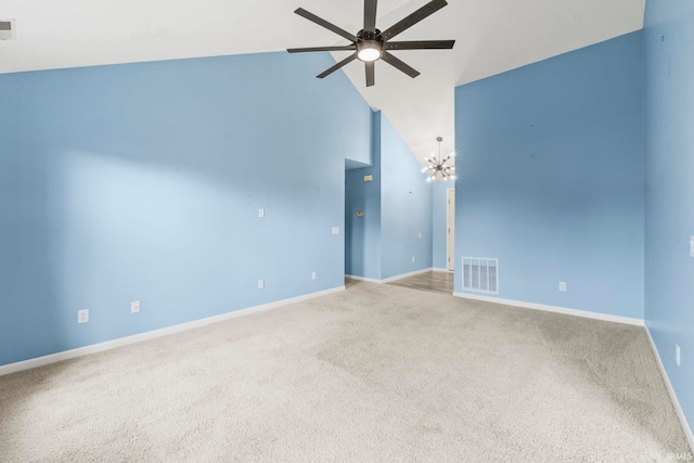 carpeted empty room with high vaulted ceiling and ceiling fan