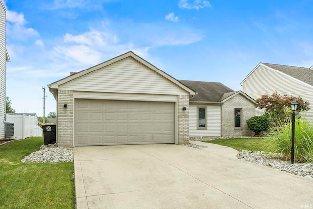 ranch-style home with a front lawn, central air condition unit, and a garage