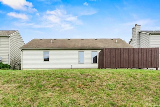 rear view of property with a lawn