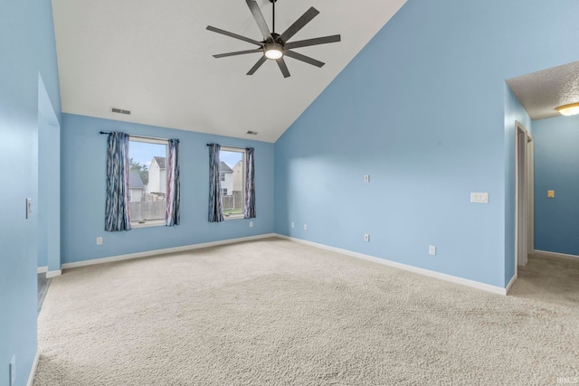 carpeted empty room featuring ceiling fan and high vaulted ceiling