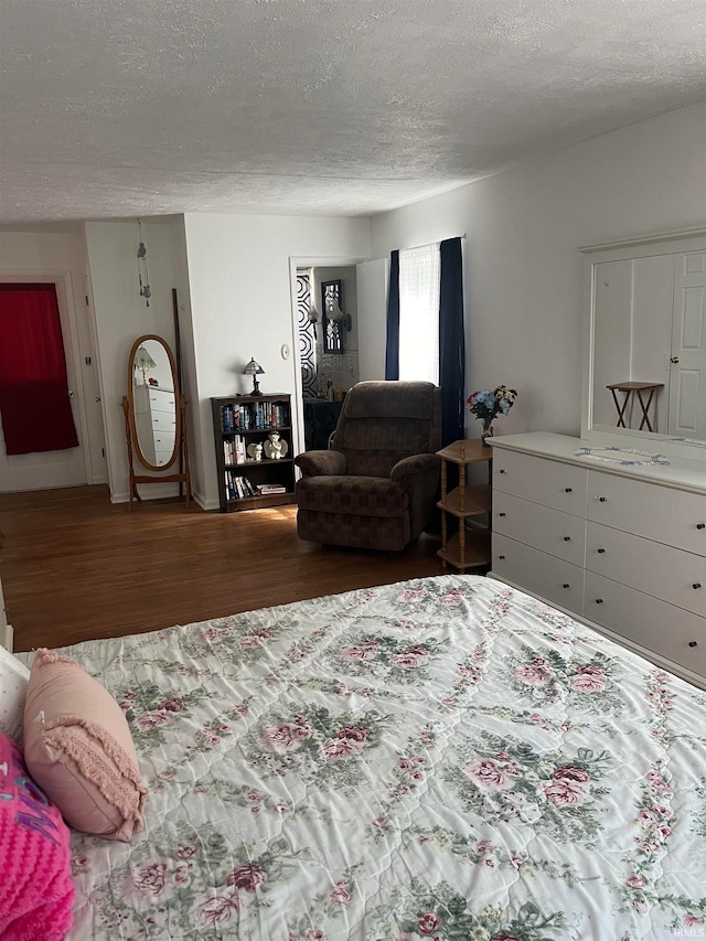 bedroom featuring a textured ceiling and hardwood / wood-style floors