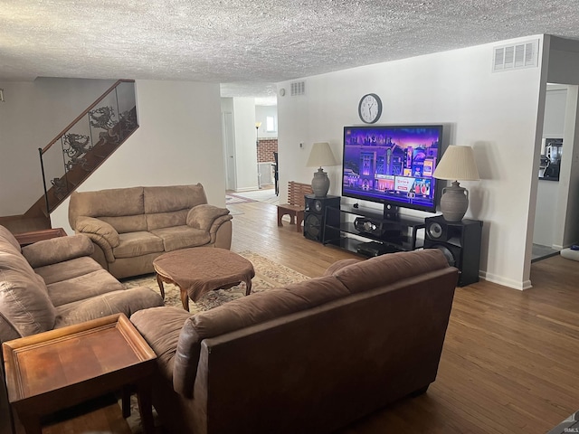 living room featuring a textured ceiling and hardwood / wood-style flooring