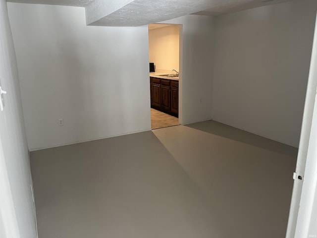 empty room featuring a textured ceiling and sink