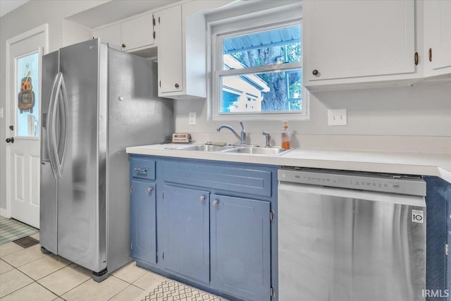 kitchen featuring white cabinetry, light tile patterned floors, appliances with stainless steel finishes, and sink