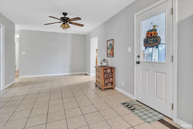 foyer featuring light tile patterned flooring and ceiling fan