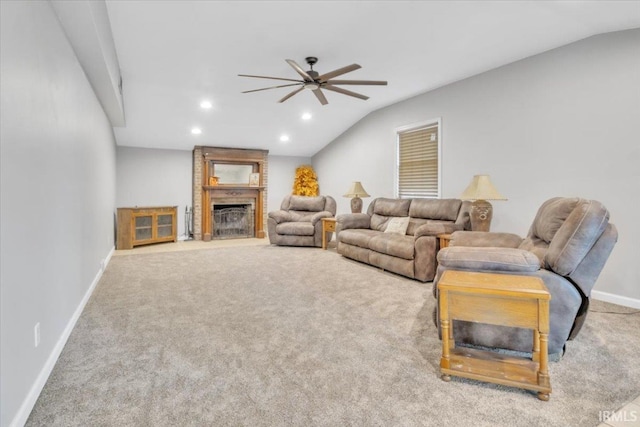 carpeted living room featuring ceiling fan, lofted ceiling, and a fireplace