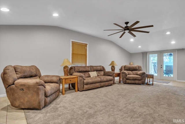 tiled living room featuring lofted ceiling, french doors, and ceiling fan