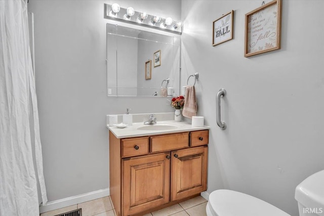 bathroom featuring toilet, vanity, and tile patterned floors