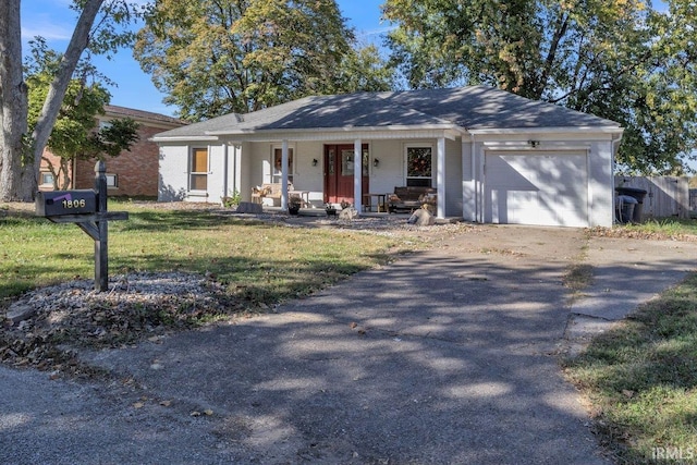 ranch-style house featuring a garage, a front lawn, and a porch