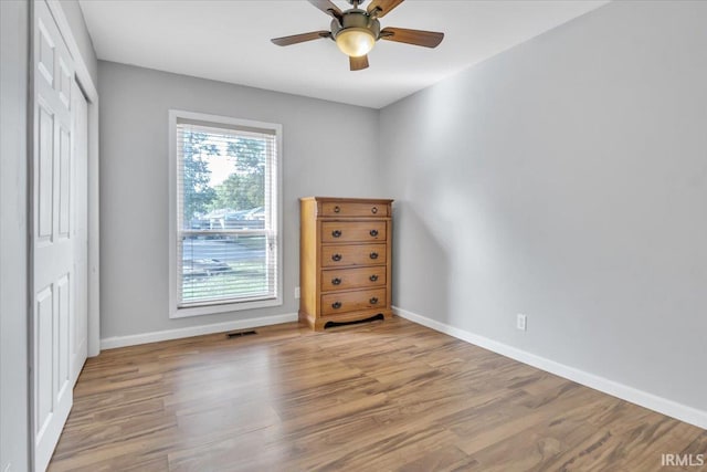 empty room featuring light hardwood / wood-style flooring and ceiling fan