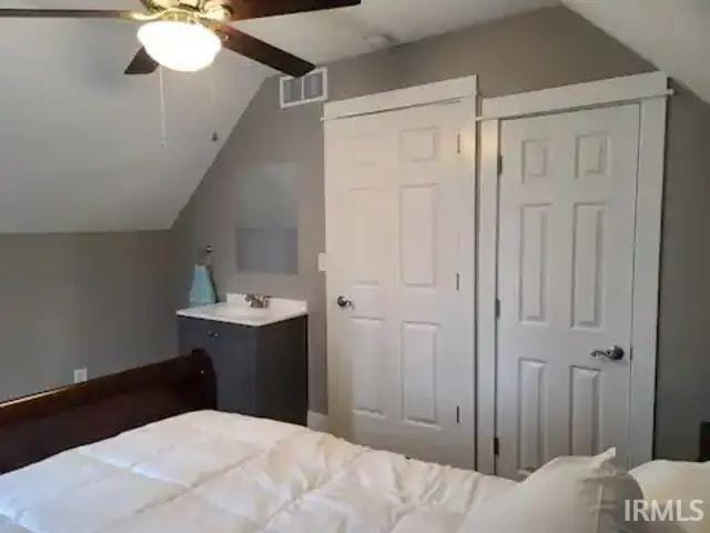 bedroom featuring vaulted ceiling and ceiling fan