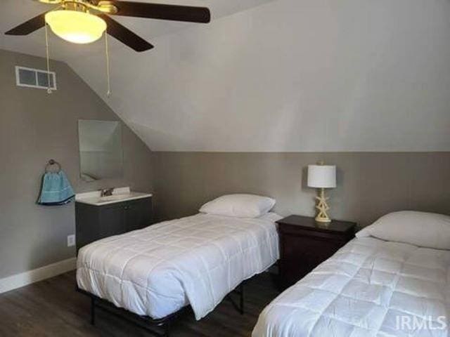 bedroom featuring lofted ceiling, dark hardwood / wood-style floors, and ceiling fan