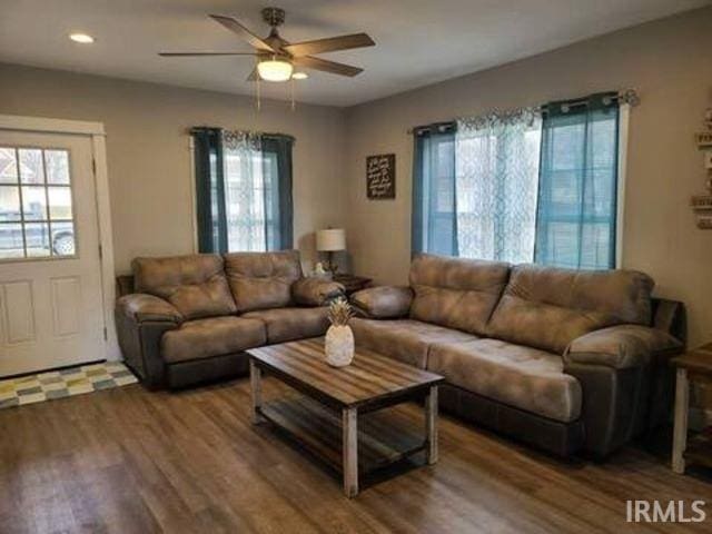 living room with hardwood / wood-style floors and ceiling fan