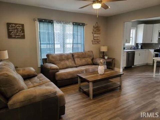 living room featuring hardwood / wood-style floors, ceiling fan, and a wealth of natural light